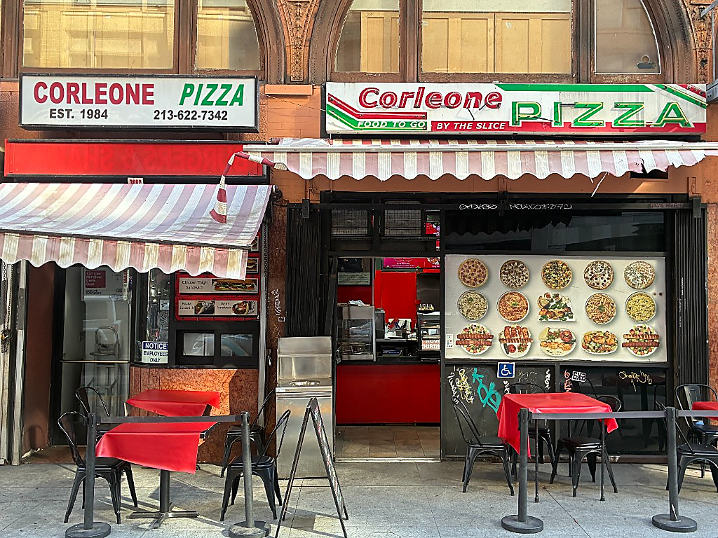 Corleone Pizza storefront with outdoor seating on West 7th Street
